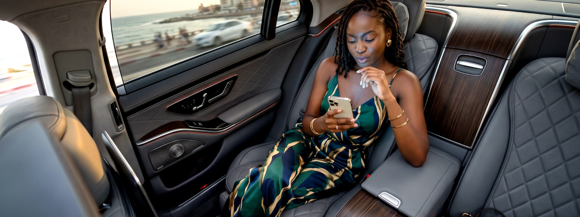Traveler using a smartphone in a luxury car