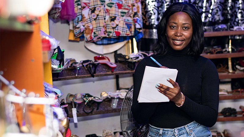 A woman with a notepad in an apparel shop